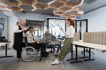 Image showing Young group of business people brainstorming together in a startup space, discussing business projects, investments, and solving challenges.