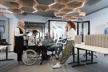 Image showing Young group of business people brainstorming together in a startup space, discussing business projects, investments, and solving challenges.