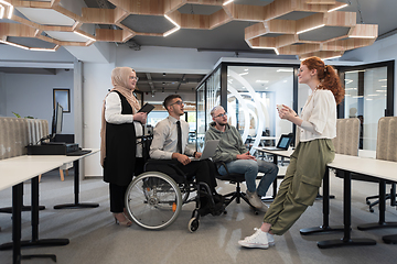 Image showing Young group of business people brainstorming together in a startup space, discussing business projects, investments, and solving challenges.