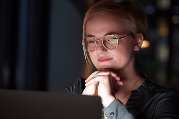 Image showing Night, laptop and reflection with woman in office for overtime, planning and serious. Glasses, technology and internet with employee and deadline at desk for goals, management solution and email