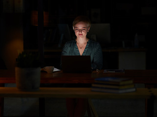 Image showing Night, laptop and concentrating with woman in office for planning, overtime or corporate mockup. Strategy, technology and email with employee typing proposal at desk for business, trading or internet