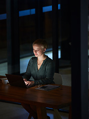 Image showing Night, laptop and serious with business woman in office for planning, overtime and corporate strategy. Deadline, technology and email with employee typing at desk for proposal, trading and internet