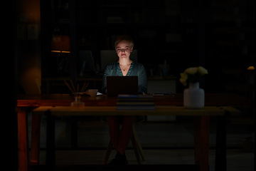 Image showing Night, laptop and serious with woman in office for planning, overtime and corporate mockup. Deadline, technology and email with employee typing proposal at desk for business, trading and internet