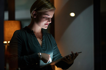 Image showing Late, night and woman typing on tablet in the evening in a modern office, workplace and startup company. Person, workaholic and female entrepreneur typing on laptop in the dark due to power cut