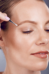 Image showing Eyebrow tweezers, face beauty and woman in studio for skincare wellness, aesthetic spa and facial. Female model, brows and hair removal for cosmetics, growth maintenance and epilation tools for shine