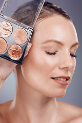 Image showing Makeup pallet, woman and face with cosmetics product for beauty, foundation and eye powder on studio background. Cosmetic care and cosmetology, eyeshadow or blush, lashes and advertising