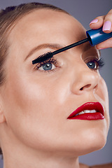 Image showing Cosmetics, woman and makeup with mascara, beauty and wellness with studio background. Face, female and lady with eyelashes, product and tool with aesthetics, organic facial and foundation on backdrop