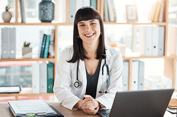 Image showing Doctor, portrait and smile of woman in hospital office ready for healthcare and wellness. Medical professional, health and happy female physician from Canada with laptop for research and telehealth.