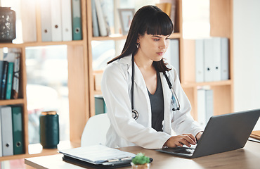 Image showing Doctor, laptop and woman typing in hospital for research, online consultation or telehealth. Technology clinic, computer and female physician writing medical report, healthcare email or wellness app.