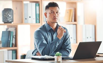 Image showing Business, portrait and man in office, serious and assertive for deal, laptop and online planning for deadline. Face, male employee and consultant with device, assertive expression and leadership