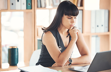 Image showing Laptop, thinking doctor and woman in hospital looking for solution to healthcare problem. Ideas, computer or female medical physician reading, focus or planning, confused or doubt while contemplating