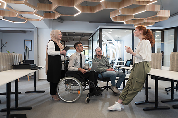 Image showing Young group of business people brainstorming together in a startup space, discussing business projects, investments, and solving challenges.