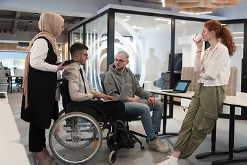 Image showing Young group of business people brainstorming together in a startup space, discussing business projects, investments, and solving challenges.