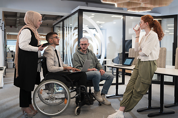 Image showing Young group of business people brainstorming together in a startup space, discussing business projects, investments, and solving challenges.