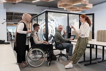 Image showing Young group of business people brainstorming together in a startup space, discussing business projects, investments, and solving challenges.