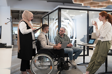 Image showing Young group of business people brainstorming together in a startup space, discussing business projects, investments, and solving challenges.