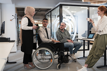 Image showing Young group of business people brainstorming together in a startup space, discussing business projects, investments, and solving challenges.