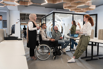 Image showing Young group of business people brainstorming together in a startup space, discussing business projects, investments, and solving challenges.