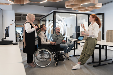 Image showing Young group of business people brainstorming together in a startup space, discussing business projects, investments, and solving challenges.