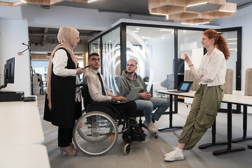 Image showing Young group of business people brainstorming together in a startup space, discussing business projects, investments, and solving challenges.