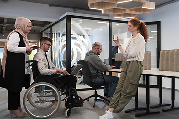 Image showing Young group of business people brainstorming together in a startup space, discussing business projects, investments, and solving challenges.