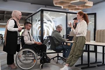 Image showing Young group of business people brainstorming together in a startup space, discussing business projects, investments, and solving challenges.