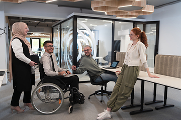 Image showing Young group of business people brainstorming together in a startup space, discussing business projects, investments, and solving challenges.