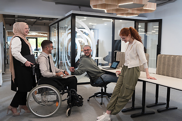 Image showing Young group of business people brainstorming together in a startup space, discussing business projects, investments, and solving challenges.