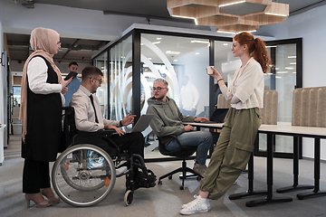 Image showing Young group of business people brainstorming together in a startup space, discussing business projects, investments, and solving challenges.