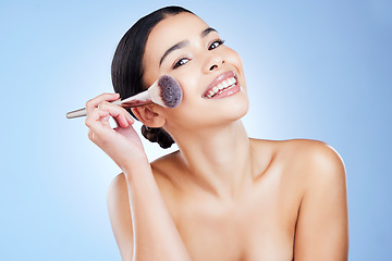 Image showing Makeup brush, beauty and portrait of woman with smile on blue background for cosmetics, powder and foundation. Skincare, facial and girl face with cosmetology tools for products, salon and treatment