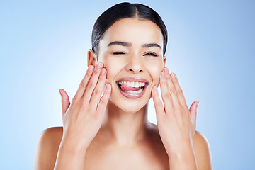 Image showing Skincare, beauty and portrait of woman with tongue out in studio of makeup, cosmetics or blue background. Young female model, funny face and wink expression for facial aesthetic, glow and happy emoji