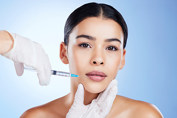 Image showing Plastic surgery, woman and surgeon hands for beauty, filler syringe and change in studio. Aesthetic model person and doctor for cosmetic injection, face transformation or dermatology blue background