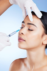 Image showing Plastic surgery, surgeon hands and woman for beauty, filler injection and change in studio. Aesthetic model person and doctor for cosmetic surgery, face transformation or dermatology blue background