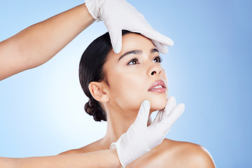 Image showing Face, plastic surgery and doctor hands on woman for beauty, filler and change in studio. Aesthetic model person and surgeon for cosmetic facial transformation or dermatology on gradient background