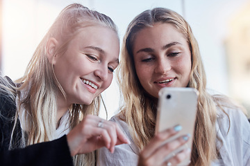 Image showing Phone, social media and friends laughing at trending meme on the internet, web or website together outdoors in a city. People, app and women scrolling online sharing or streaming a video