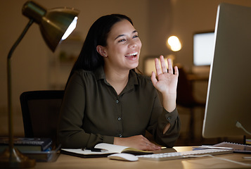 Image showing Business woman, night and video call or webinar at desk in dark office for communication. Happy entrepreneur person wave hand for hello online for learning, training or virtual seminar meeting