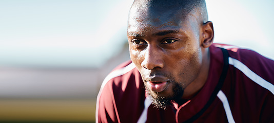 Image showing Tired, breathing and black man in sports training, competition or game focus on rugby field, blue sky mockup. Breathe, sweating and athlete or person thinking of workout, exercise or fitness strategy