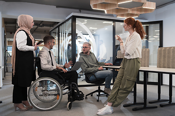 Image showing Young group of business people brainstorming together in a startup space, discussing business projects, investments, and solving challenges.