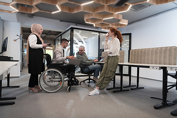 Image showing Young group of business people brainstorming together in a startup space, discussing business projects, investments, and solving challenges.