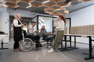 Image showing Young group of business people brainstorming together in a startup space, discussing business projects, investments, and solving challenges.