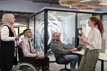 Image showing Young group of business people brainstorming together in a startup space, discussing business projects, investments, and solving challenges.