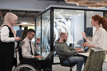 Image showing Young group of business people brainstorming together in a startup space, discussing business projects, investments, and solving challenges.