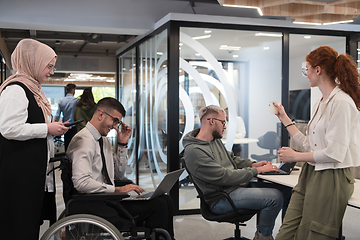 Image showing Young group of business people brainstorming together in a startup space, discussing business projects, investments, and solving challenges.