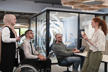 Image showing Young group of business people brainstorming together in a startup space, discussing business projects, investments, and solving challenges.