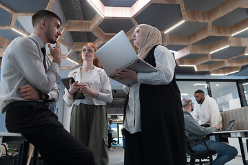 Image showing Young group of business people brainstorming together in a startup space, discussing business projects, investments, and solving challenges.