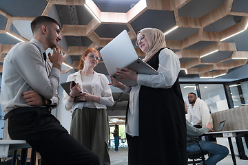 Image showing Young group of business people brainstorming together in a startup space, discussing business projects, investments, and solving challenges.