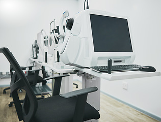 Image showing Ophthalmology machine, eye test and interior with computer for healthcare, wellness and vision in office. Optometrist consultation room, pc and furniture with digital equipment by blurred background