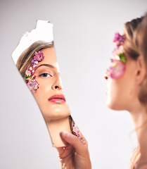Image showing Beauty, reflection and portrait of a woman with a broken mirror for an insecurity and problem. Mental health, makeup and face of a girl getting ready and looking at face isolated on a background