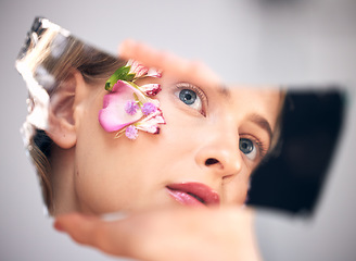 Image showing Beauty, reflection and woman with flowers, skincare and natural cosmetics for morning routine, grooming and treatment. Mirror, female and lady with makeup, plants or floral with dermatology or luxury