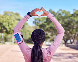 Image showing Fitness, heart hands and black woman with phone monitor for running, cardio and workout progress, health and data. Sports person rear or athlete runner with love emoji and smartphone for training